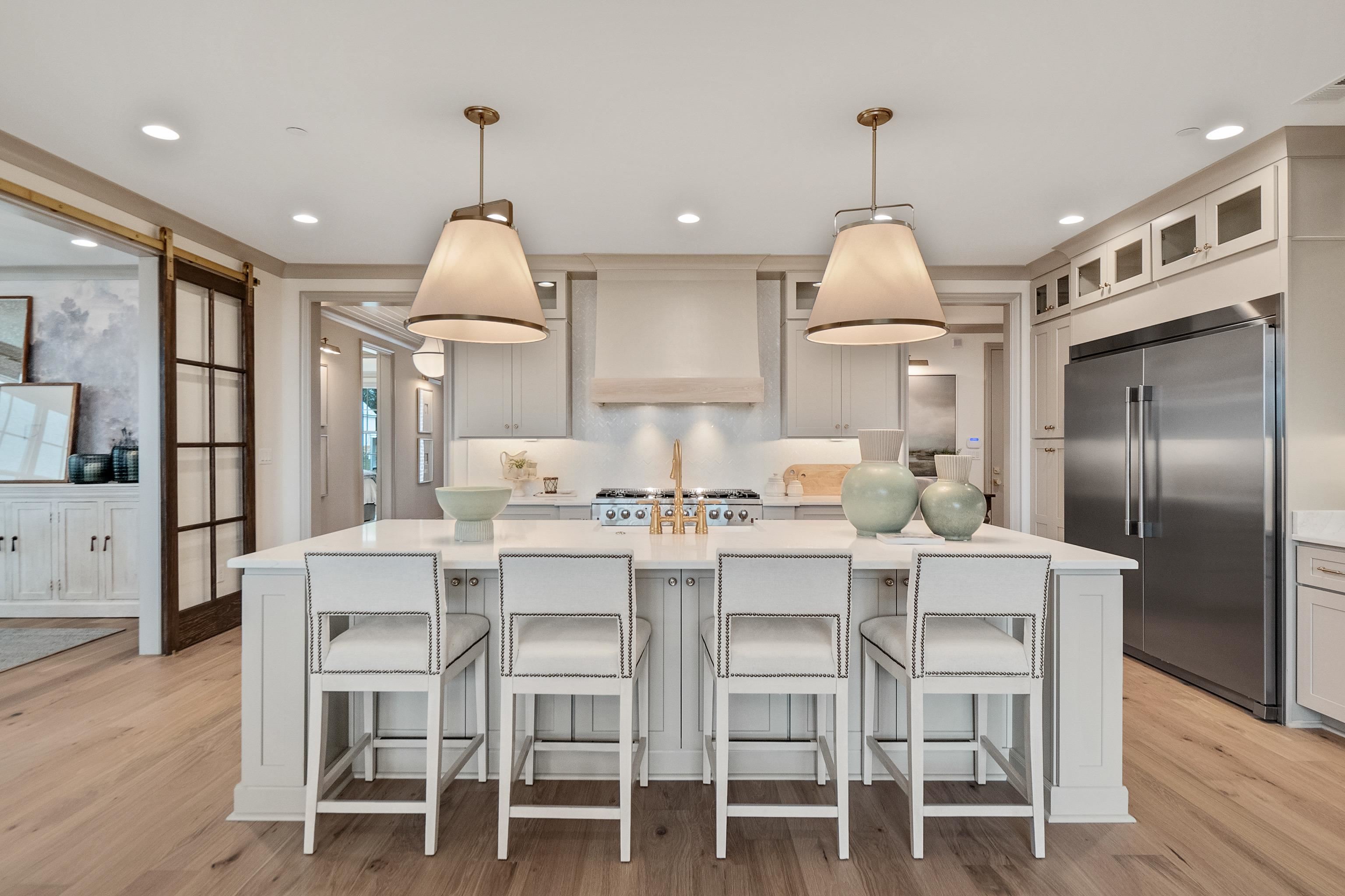 356 River Branch Drive Collierville, TN 38017 - Photo 3 of 31 a kitchen with a dining table chairs refrigerator and cabinets