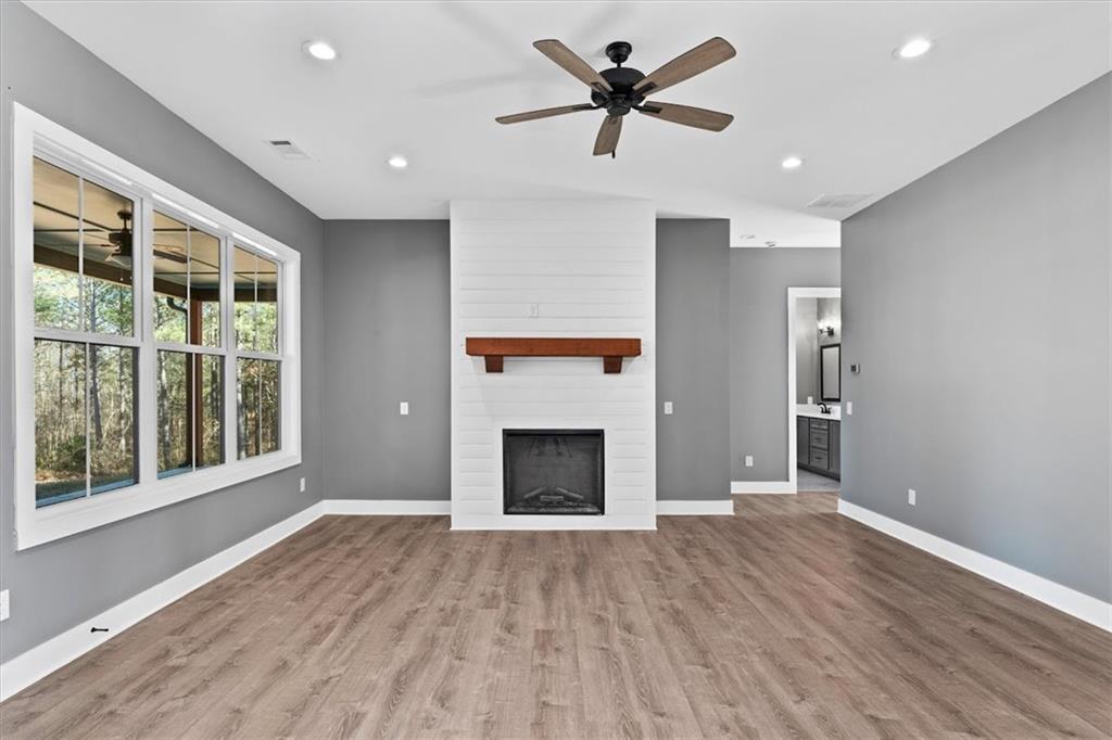 1374 Morgan Road Bremen, GA 30110 - Photo 14 of 50 a view of empty room with wooden floor and fireplace