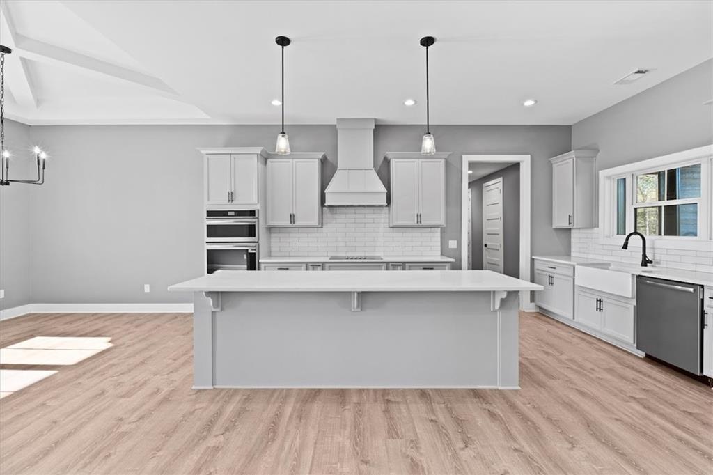 1374 Morgan Road Bremen, GA 30110 - Photo 16 of 50 a large kitchen with stainless steel appliances a large counter top a sink a refrigerator and a window