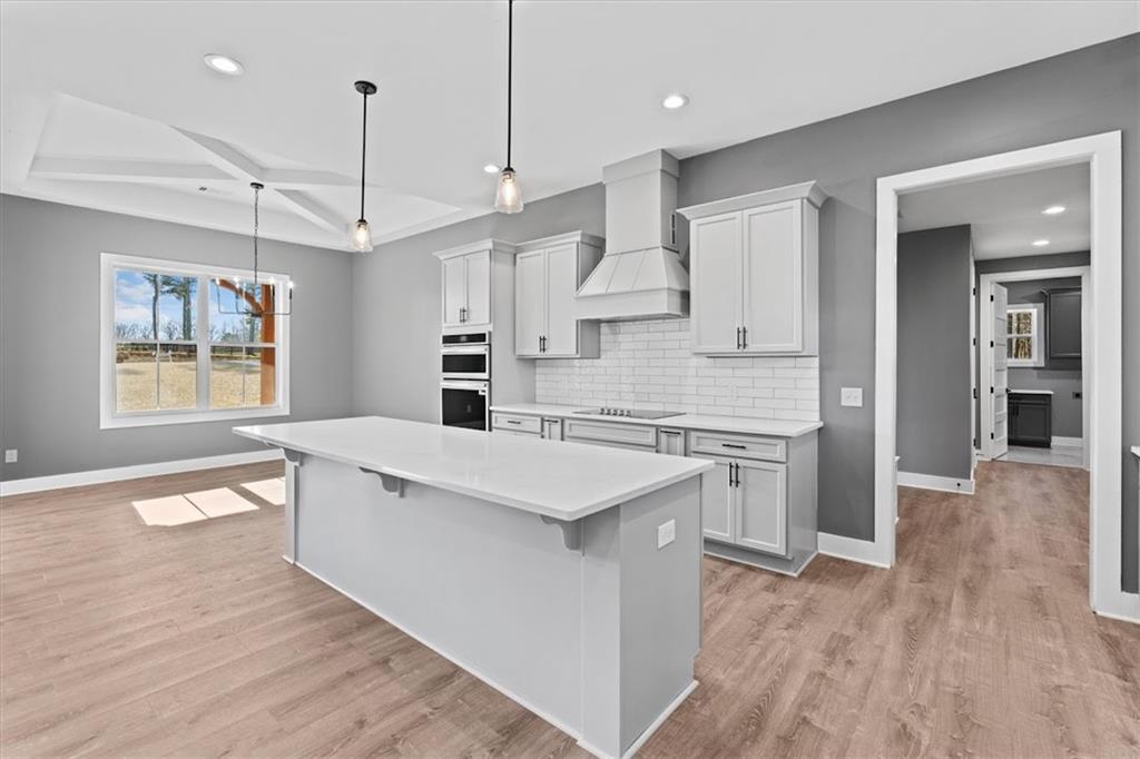 1374 Morgan Road Bremen, GA 30110 - Photo 20 of 50 a kitchen with stainless steel appliances kitchen island hardwood floor sink and stove