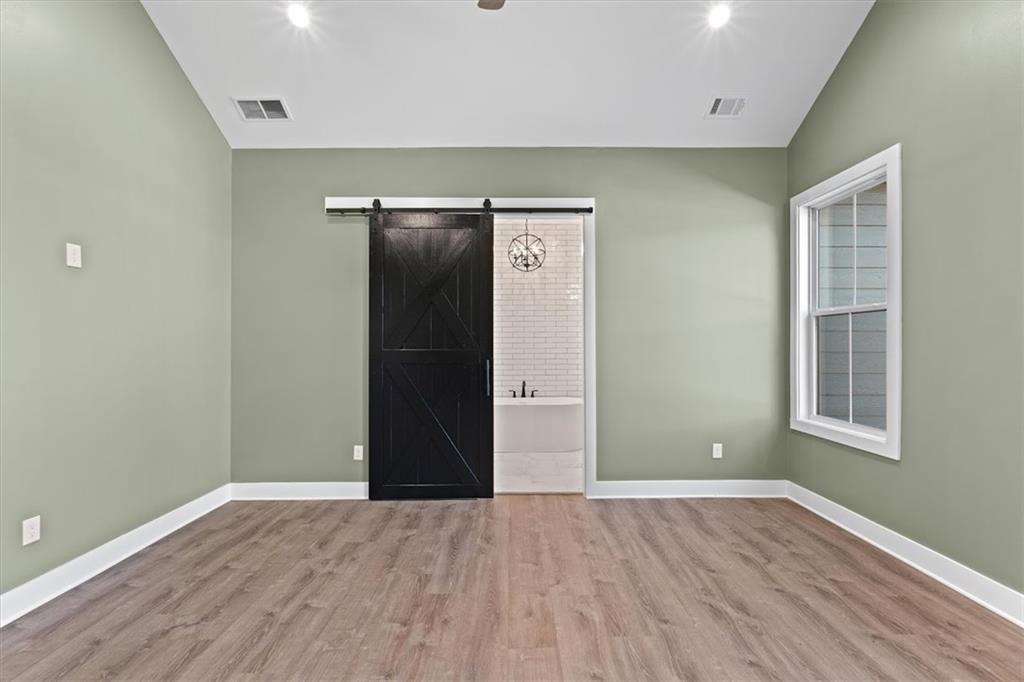 1374 Morgan Road Bremen, GA 30110 - Photo 24 of 50 an empty room with wooden floor and windows