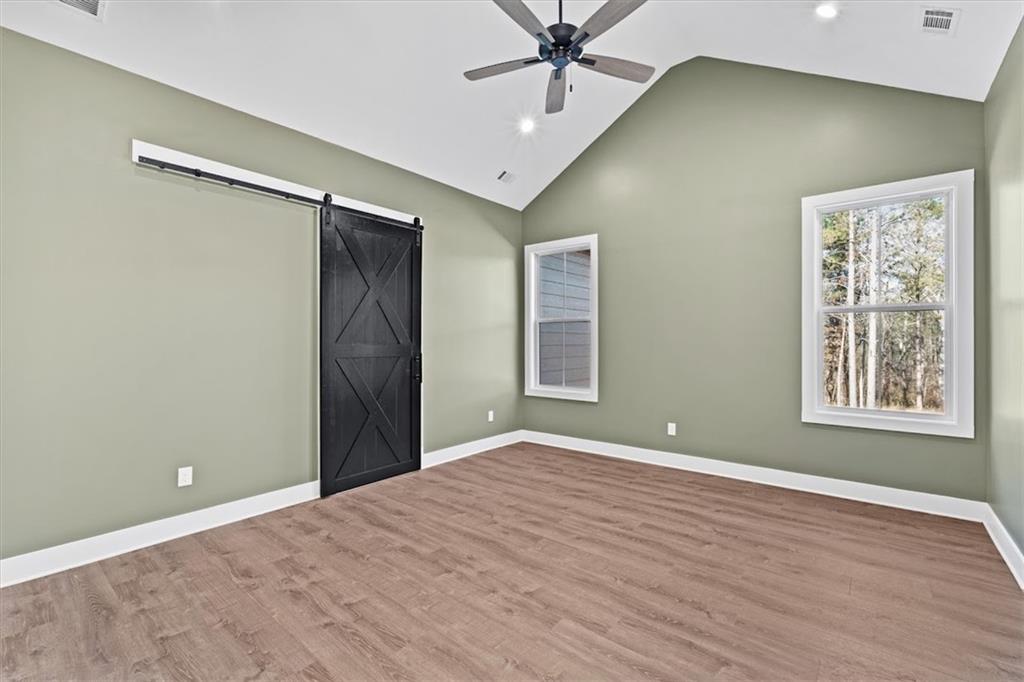 1374 Morgan Road Bremen, GA 30110 - Photo 25 of 50 a view of an empty room with a window and a ceiling fan