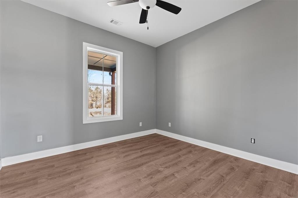 1374 Morgan Road Bremen, GA 30110 - Photo 32 of 50 wooden floor in an empty room with a window