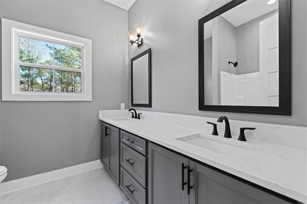 1374 Morgan Road Bremen, GA 30110 - Photo 33 of 50 a bathroom with 2 sink and a mirror