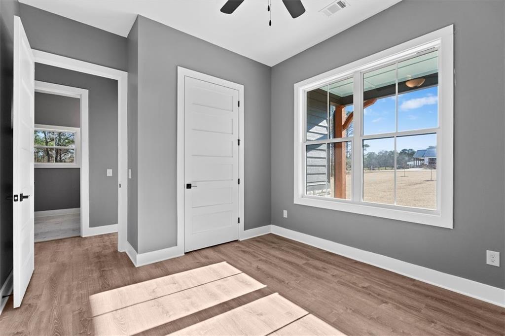 1374 Morgan Road Bremen, GA 30110 - Photo 36 of 50 an empty room with a window and wooden floor