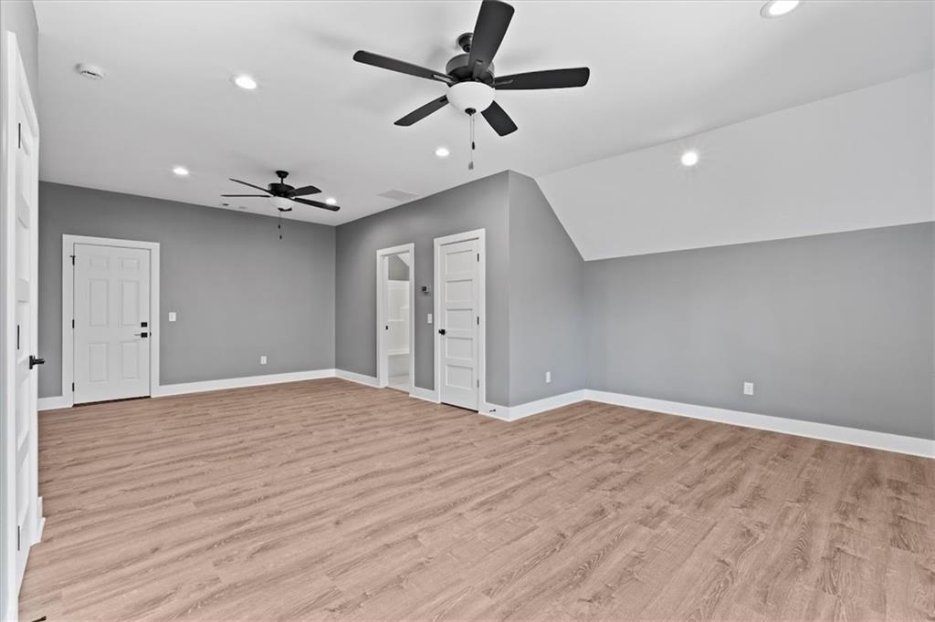 1374 Morgan Road Bremen, GA 30110 - Photo 40 of 50 a view of an empty room with a ceiling fan and a kitchen