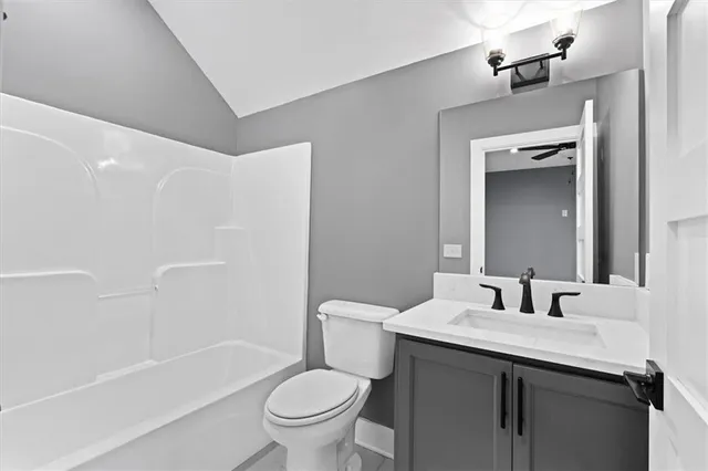 a view of a hall with wooden floor and door