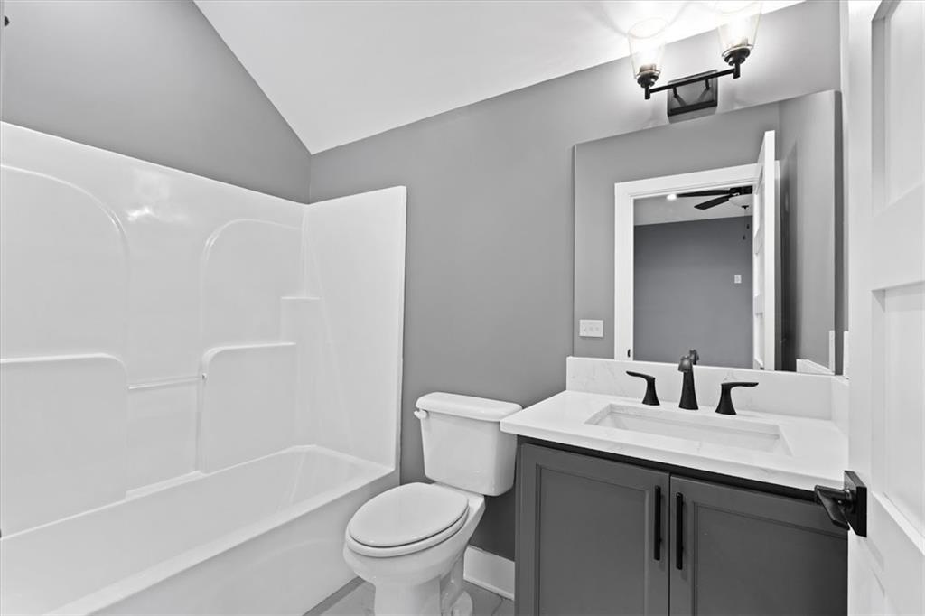 1374 Morgan Road Bremen, GA 30110 - Photo 42 of 50 a bathroom with a granite countertop sink toilet and shower