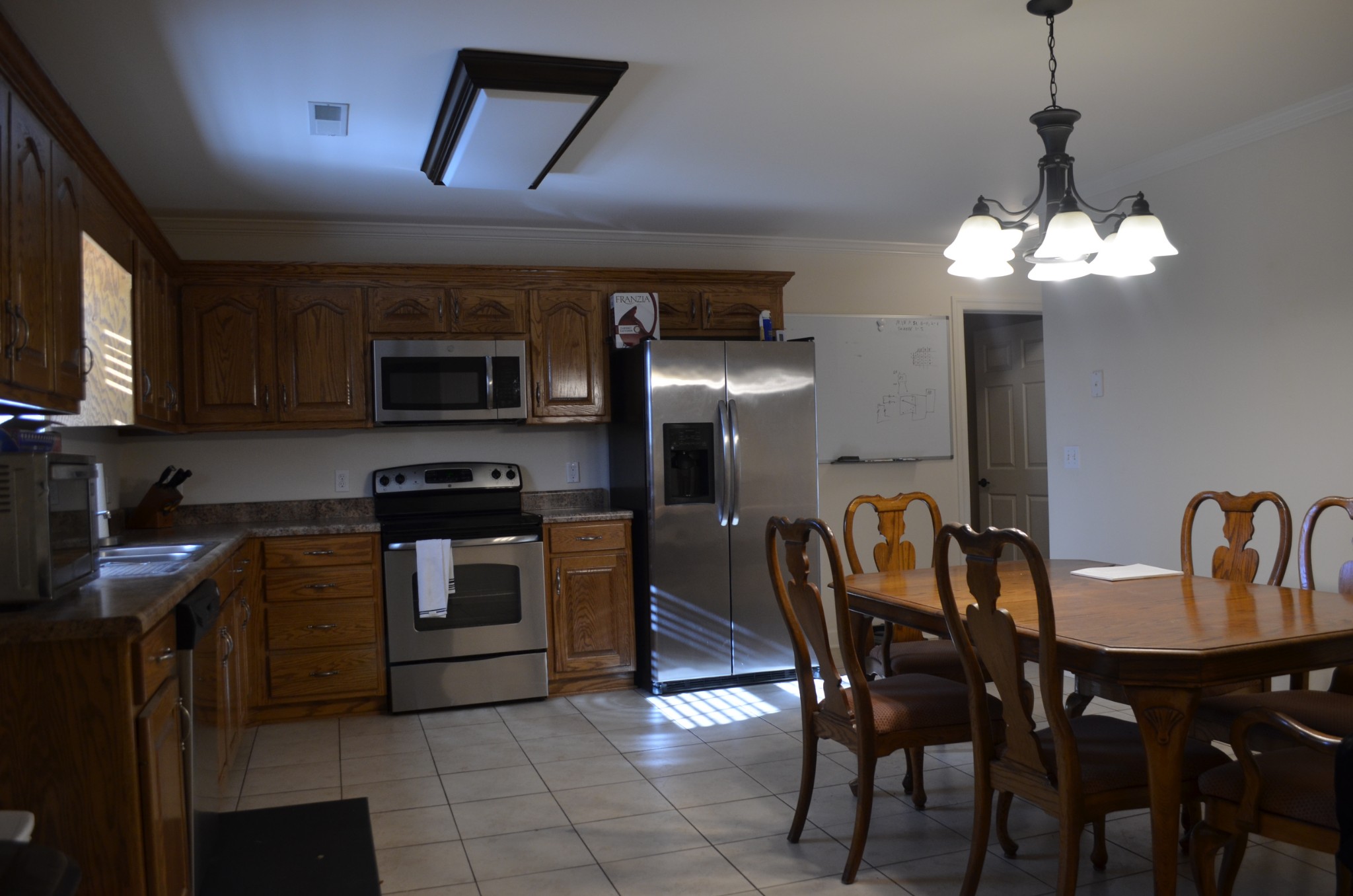 0 Riley Creek Road Normandy, TN 37360 - Photo 5 of 13 a kitchen with stainless steel appliances granite countertop a dining table chairs refrigerator and microwave