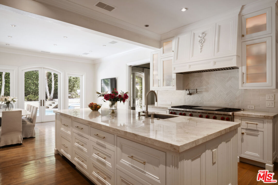 1160 Chantilly Road Los Angeles, CA 90077 - Photo 13 of 32 a kitchen with granite countertop a sink and cabinets