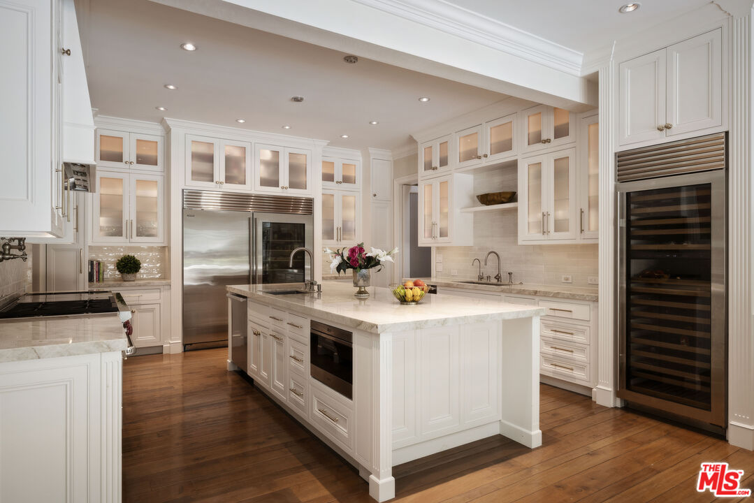 1160 Chantilly Road Los Angeles, CA 90077 - Photo 14 of 32 a kitchen with stainless steel appliances granite countertop a stove and a sink