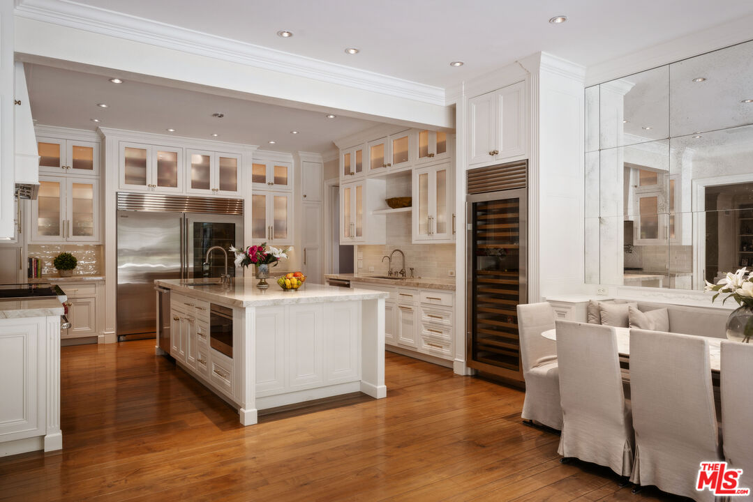 1160 Chantilly Road Los Angeles, CA 90077 - Photo 15 of 32 a kitchen with stainless steel appliances a white counter top space a stove and a refrigerator