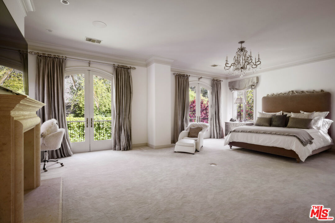 1160 Chantilly Road Los Angeles, CA 90077 - Photo 19 of 32 a spacious bedroom with a bed and large windows