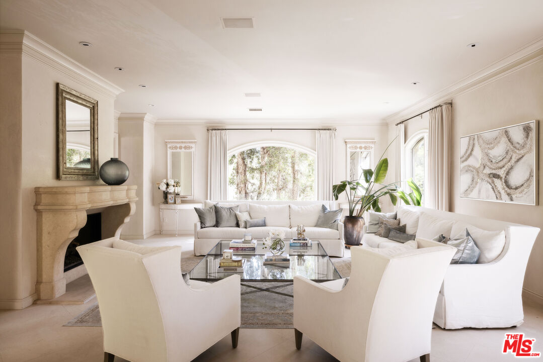 1160 Chantilly Road Los Angeles, CA 90077 - Photo 2 of 32 a living room with fireplace furniture and a large window