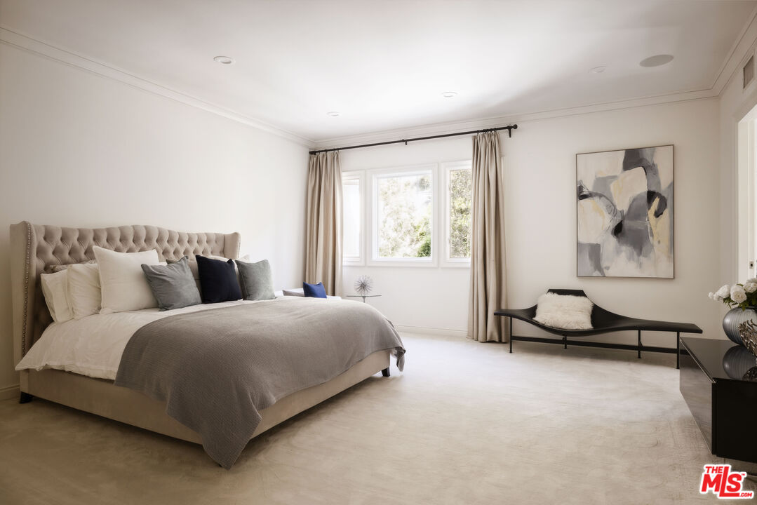 1160 Chantilly Road Los Angeles, CA 90077 - Photo 23 of 32 a bedroom with a bed and a painting on the wall