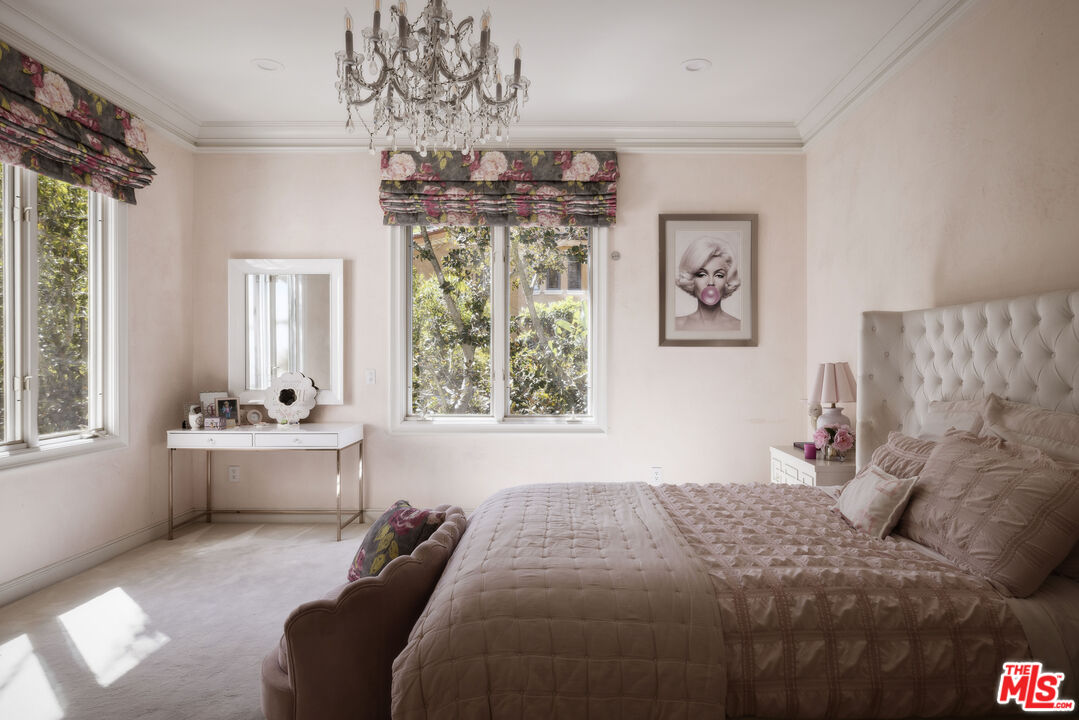 1160 Chantilly Road Los Angeles, CA 90077 - Photo 24 of 32 a bedroom with a bed and a chandelier