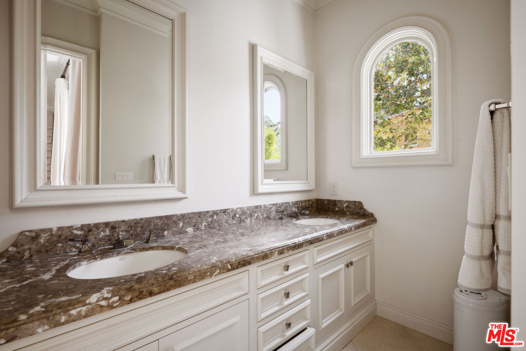 1160 Chantilly Road Los Angeles, CA 90077 - Photo 26 of 32 a bathroom with a granite countertop sink and a window