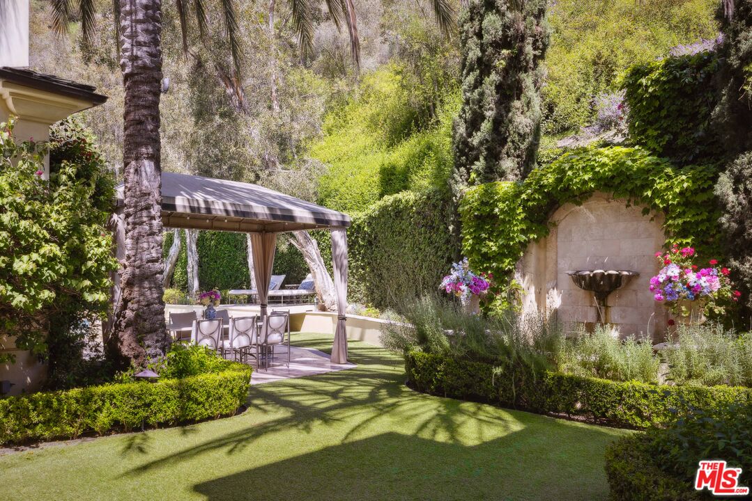 1160 Chantilly Road Los Angeles, CA 90077 - Photo 29 of 32 a view of a backyard with plants and a fountain