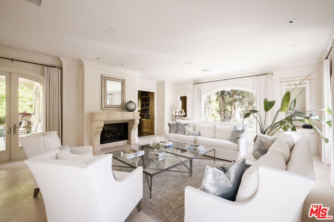 1160 Chantilly Road Los Angeles, CA 90077 - Photo 5 of 32 a living room with furniture a fireplace and a large window