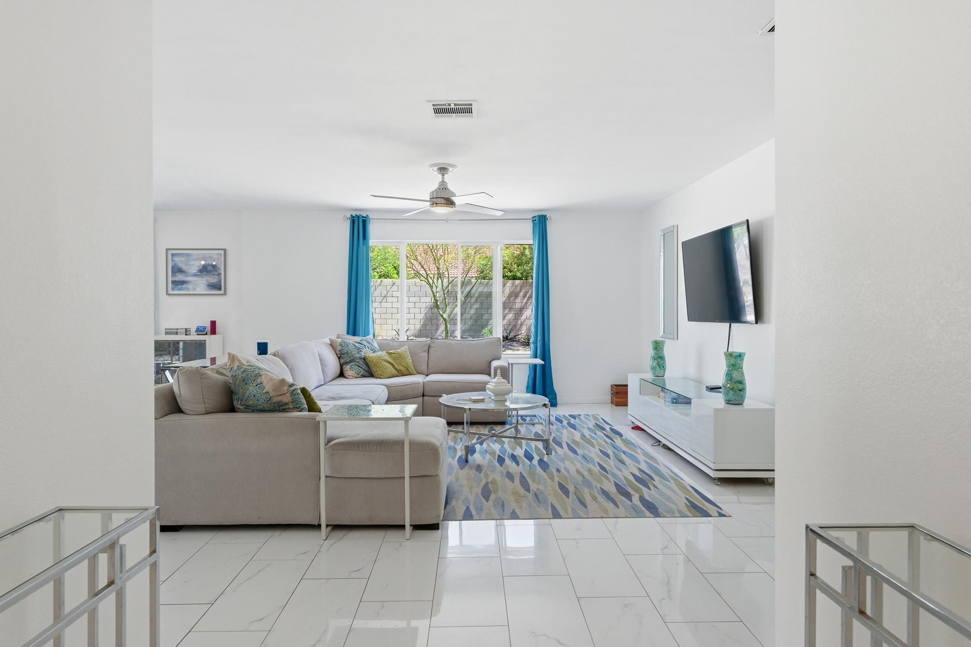 67220 Quijo Road Cathedral City, CA 92234 - Photo 20 of 26 a living room with furniture and a flat screen tv