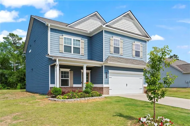 a front view of a house with a yard
