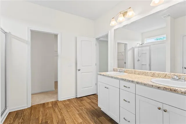 a spacious bathroom with a granite countertop sink a mirror and a