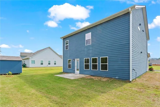 a view of a house with a backyard