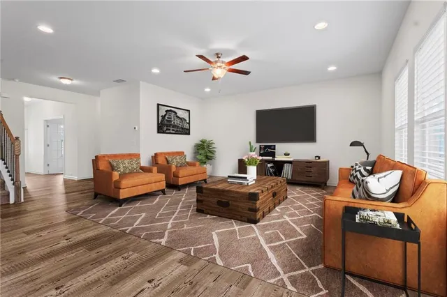 a living room with furniture and a flat screen tv