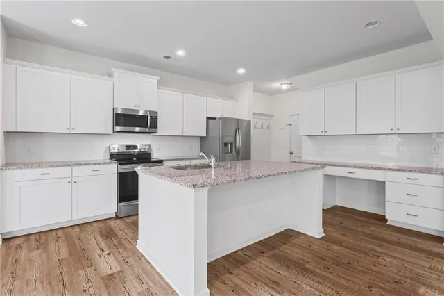 a kitchen with stainless steel appliances granite countertop a sink and cabinets