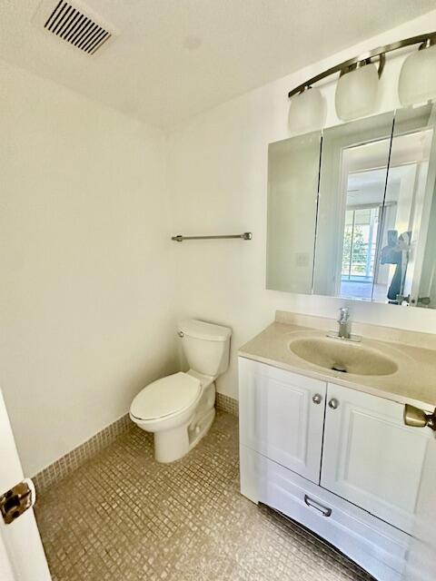 69 Dorset B Boca Raton, FL 33434 - Photo 11 of 25 a bathroom with a granite countertop sink and a mirror