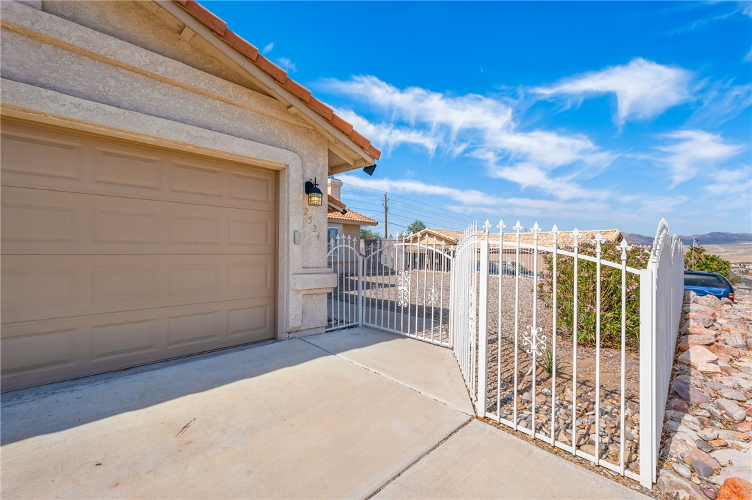 2524 South Ridge Avenue Bullhead City, AZ 86429 - Photo 7 of 64 Garage featuring a gate and concrete driveway
