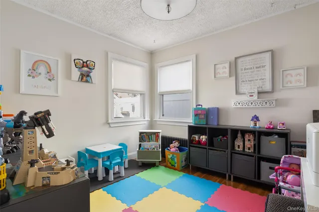 a room with furniture toys and a baby crib