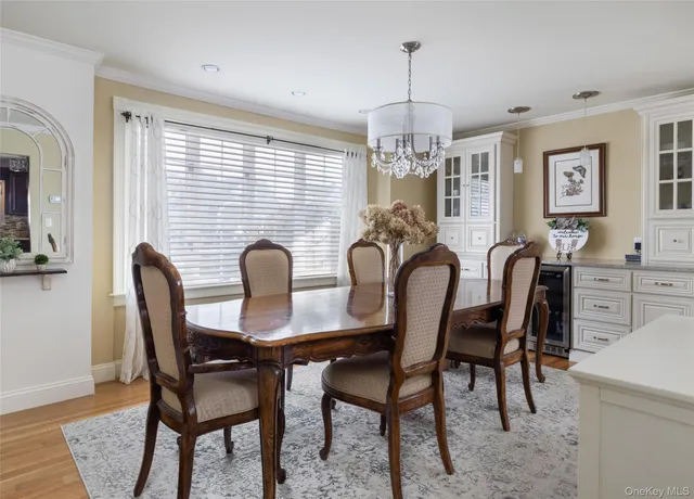a view of a a dining room with furniture window and wooden floor