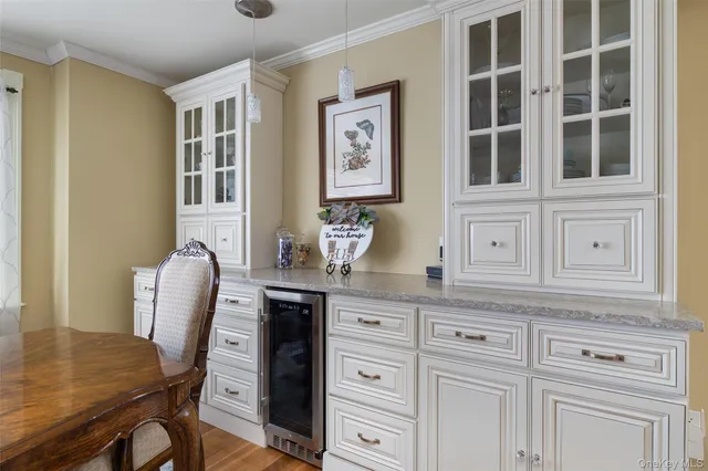 a kitchen with stainless steel appliances granite countertop a table and chair