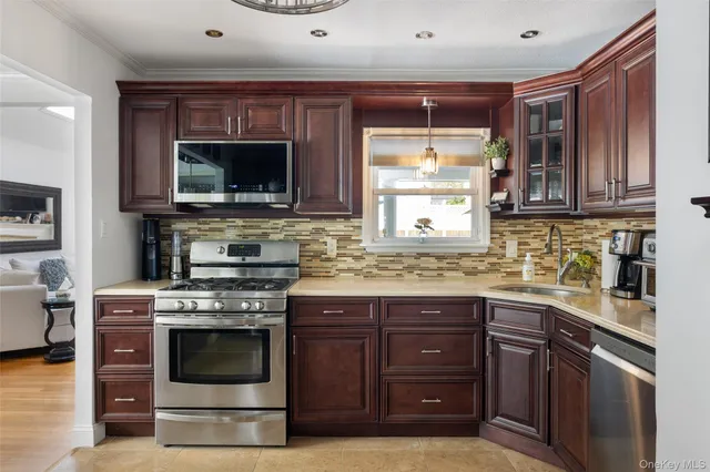 a kitchen with stainless steel appliances granite countertop a stove microwave and cabinets