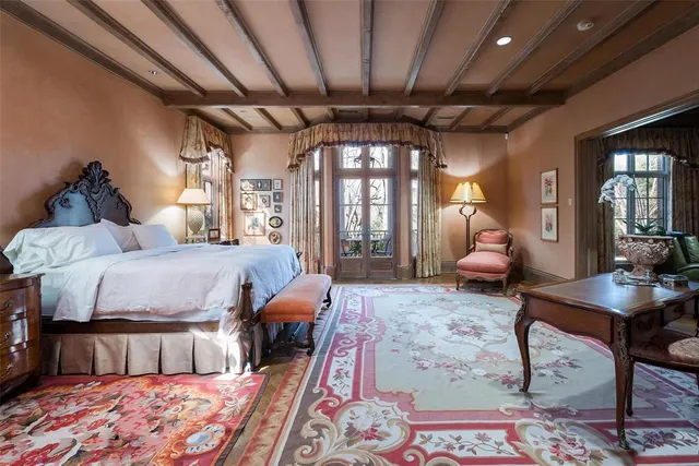 a bedroom with furniture and a large window