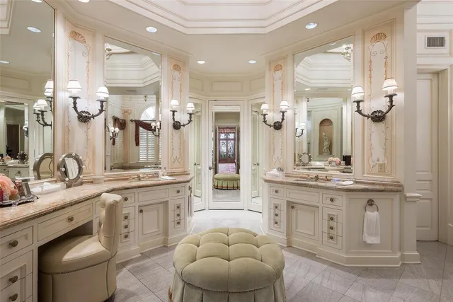 a spacious bathroom with a granite countertop sink a toilet and a mirror