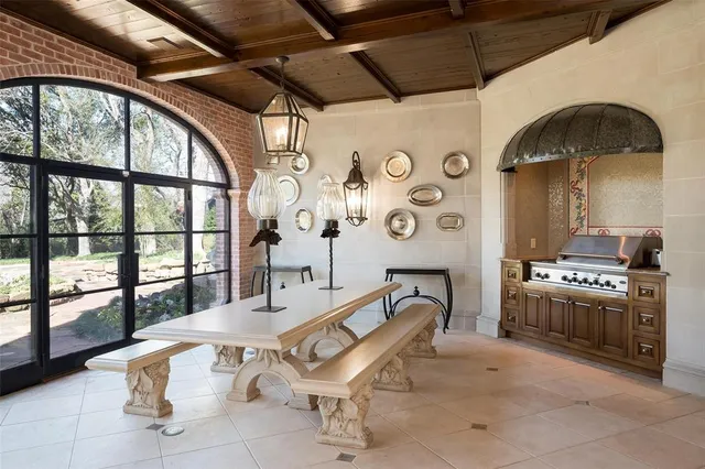 a spacious bedroom with a bed a mirror and a window