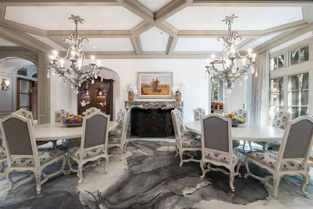 a view of a dining room with furniture and chandelier