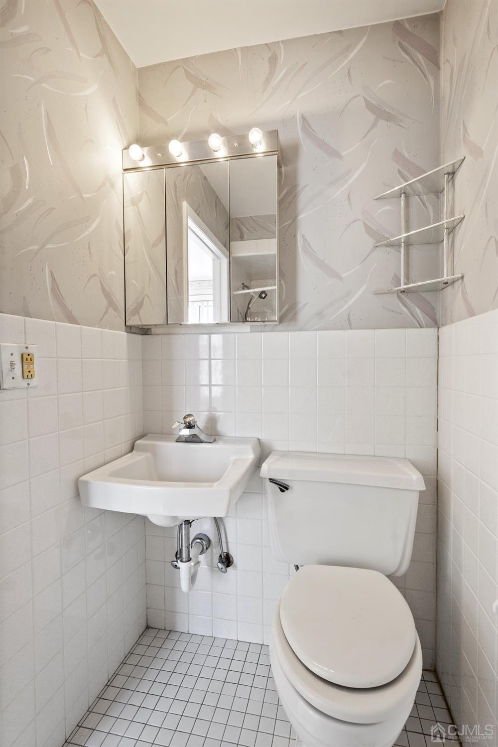 7 Garside Place Clark, NJ 07066 - Photo 17 of 34 a bathroom with a sink a toilet and a mirror