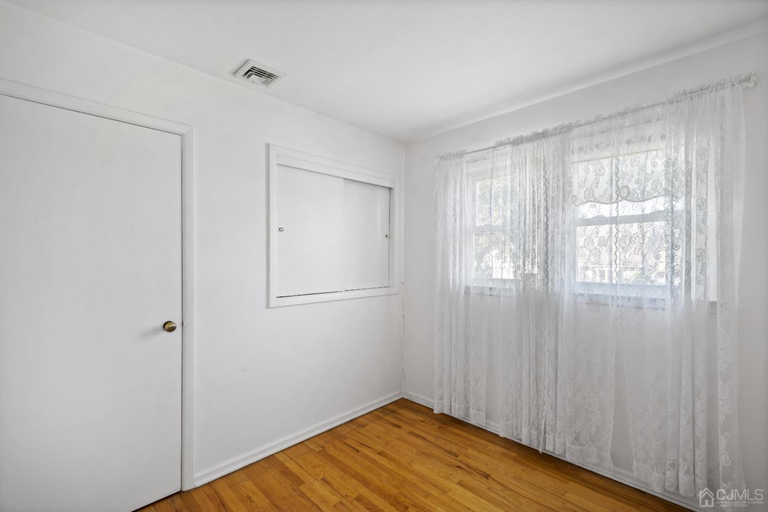 7 Garside Place Clark, NJ 07066 - Photo 23 of 34 a view of empty room with wooden floor and fan