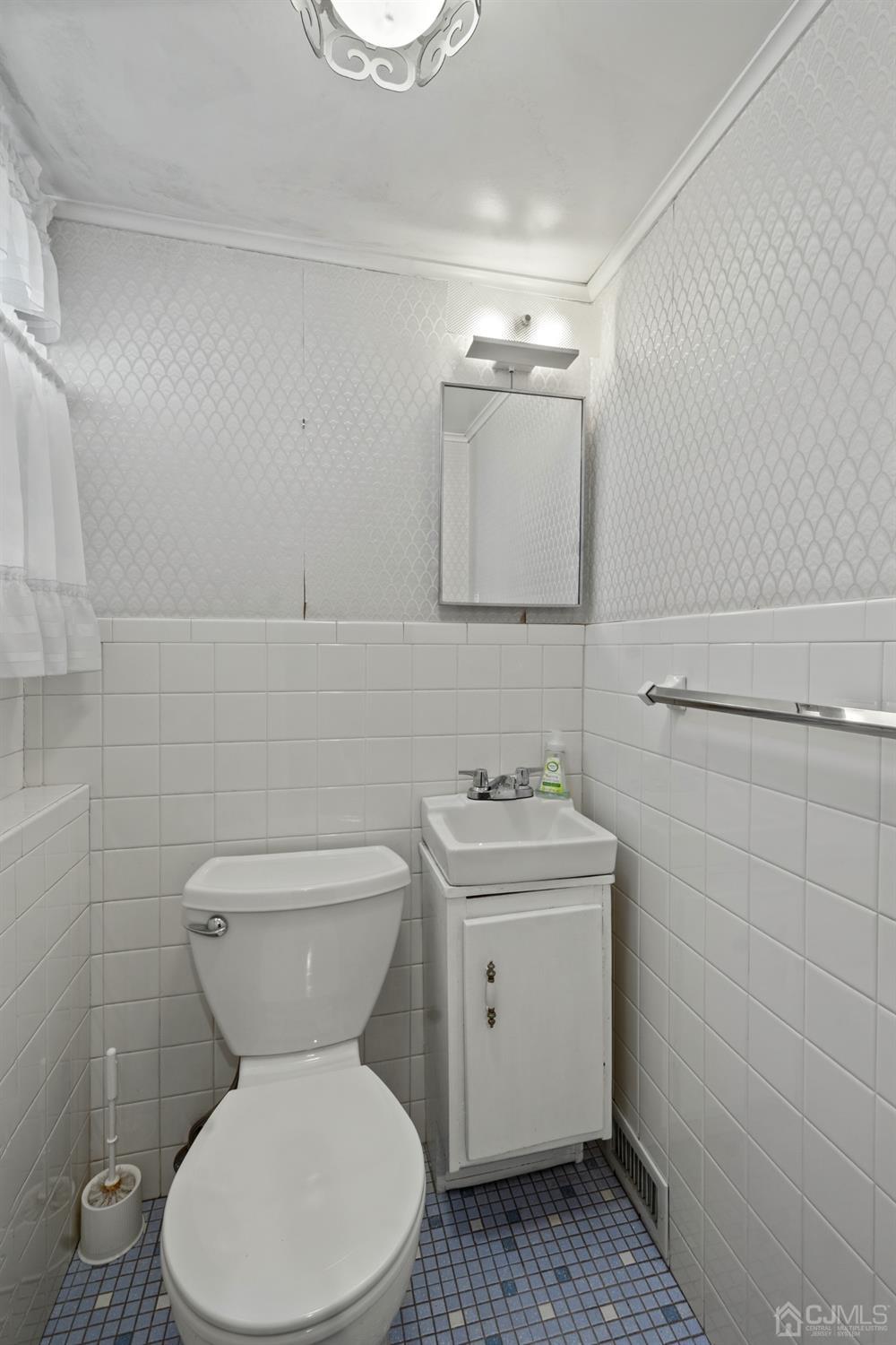 7 Garside Place Clark, NJ 07066 - Photo 31 of 34 a bathroom with a toilet sink and mirror