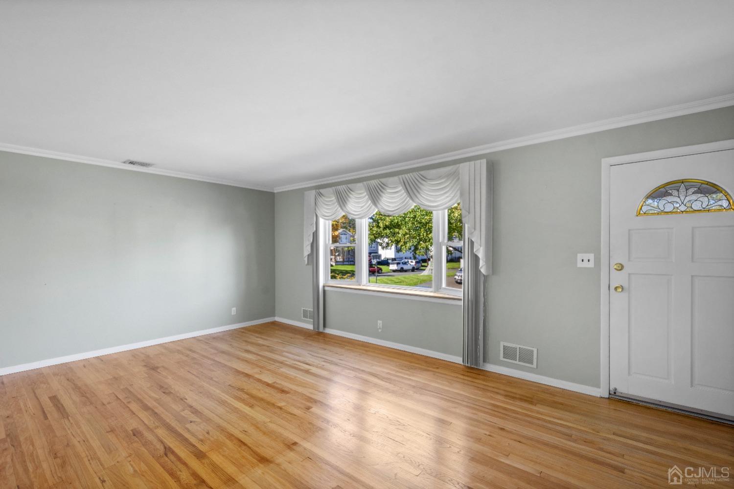 7 Garside Place Clark, NJ 07066 - Photo 6 of 34 a view of empty room with wooden floor and fan