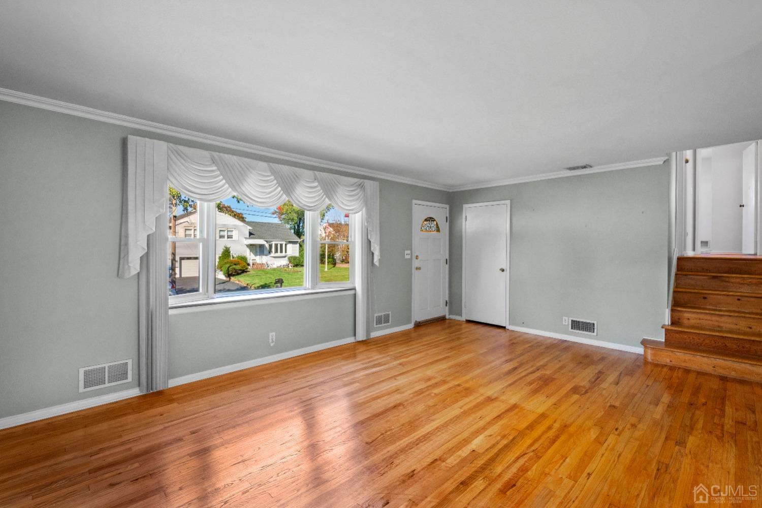 7 Garside Place Clark, NJ 07066 - Photo 7 of 34 a view of empty room with wooden floor and fan