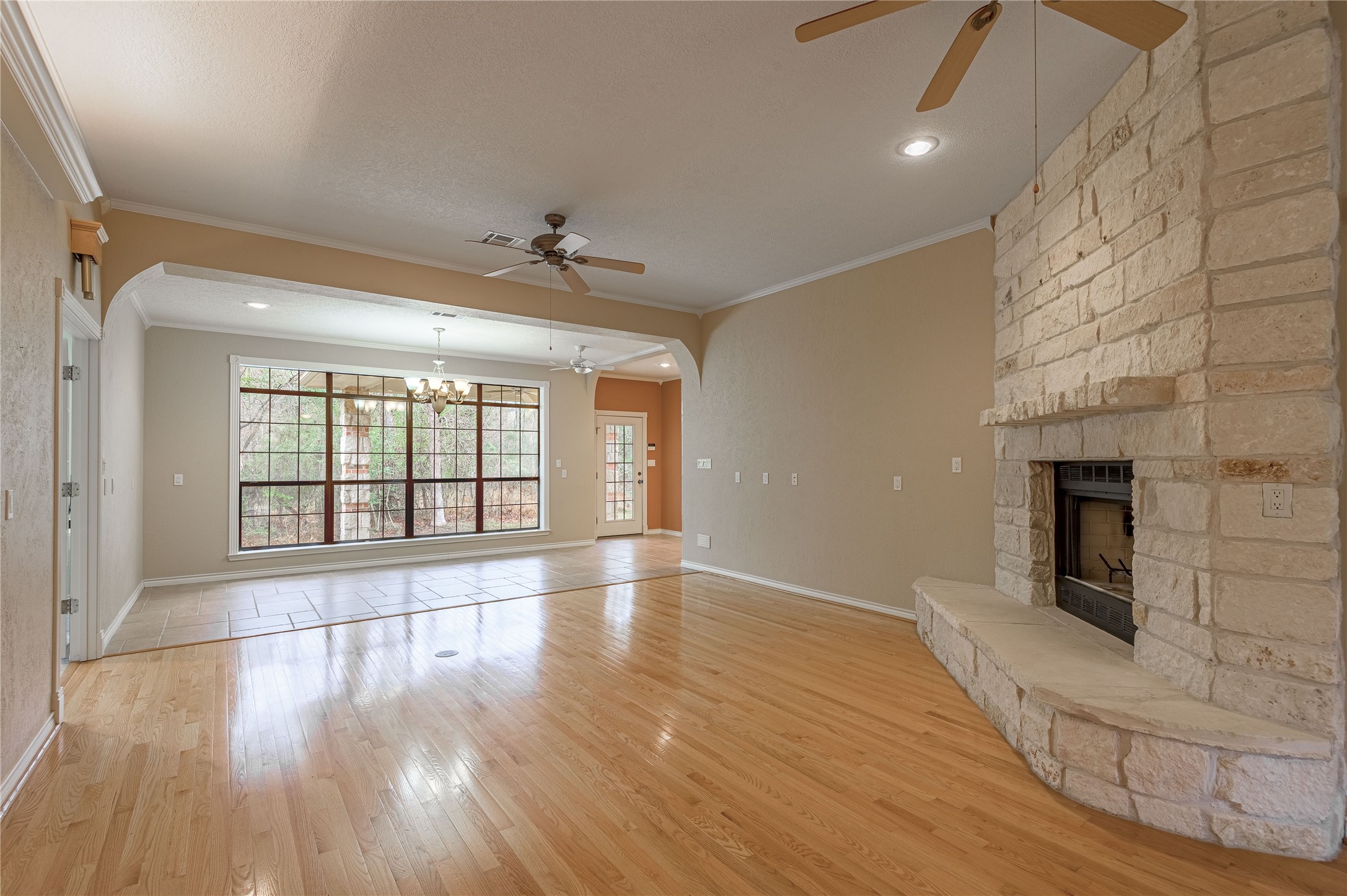 20 Tall Timbers Way Huntsville, TX 77320 - Photo 9 of 41 a view of an empty room with wooden floor and a fireplace