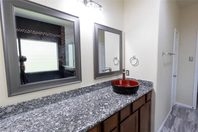 a room with a sink and a mirror