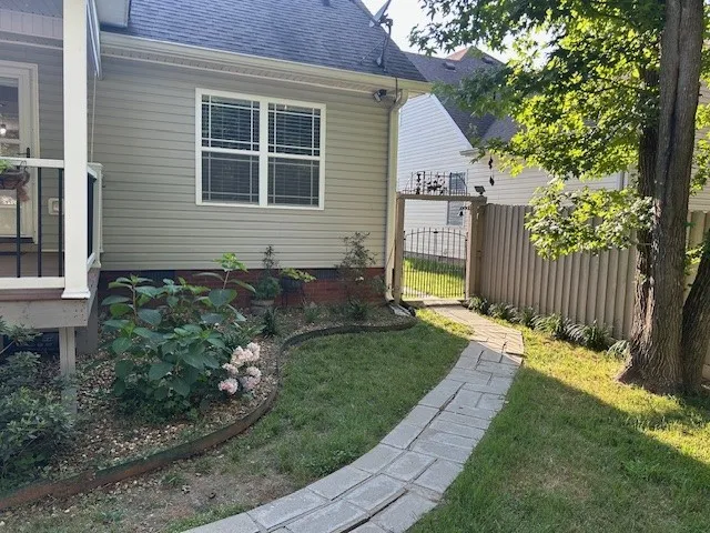 a view of a house with a yard and sitting area