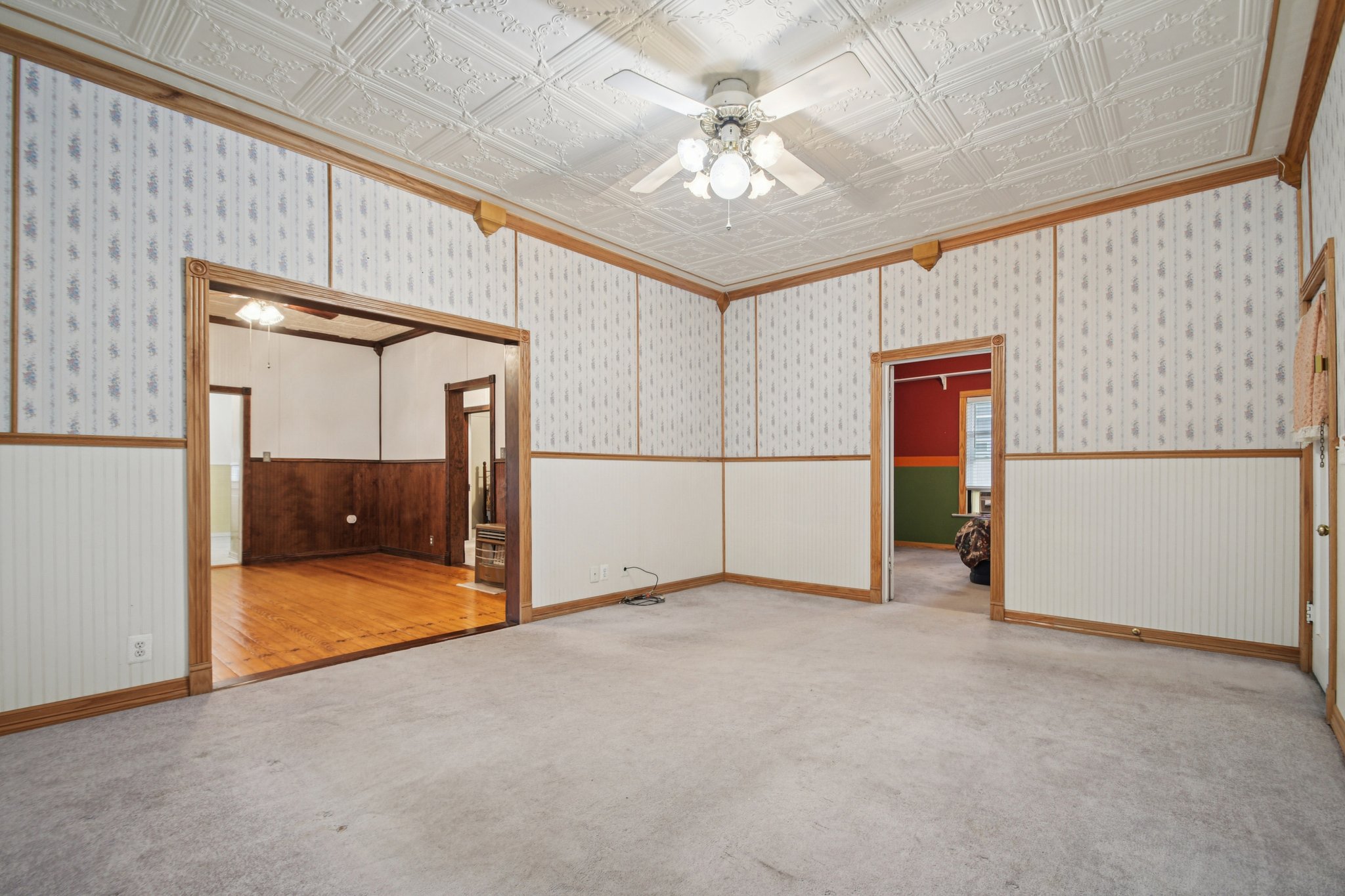 611 North Main Street Elgin, TX 78621 - Photo 6 of 26 an empty room with chandelier fan and windows