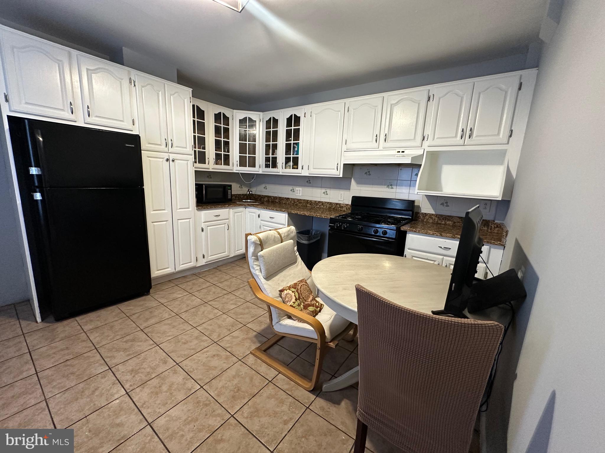 1707 Harman Avenue Baltimore, MD 21230 - Photo 13 of 18 a kitchen with stainless steel appliances a stove a refrigerator a sink a counter space and cabinets