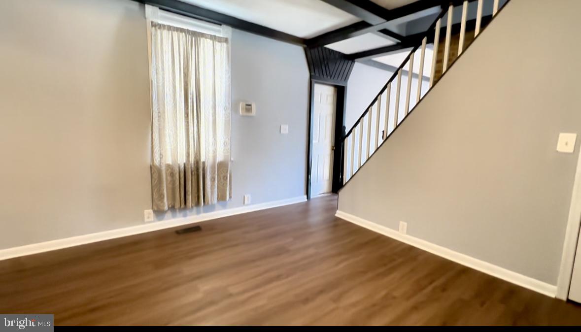 1707 Harman Avenue Baltimore, MD 21230 - Photo 7 of 18 an entryway and an empty room with wooden floor